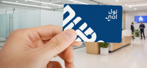 Commuter tapping a Nol card at a Dubai Metro gate with green light confirmation